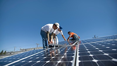 A group of men working on solar panelling